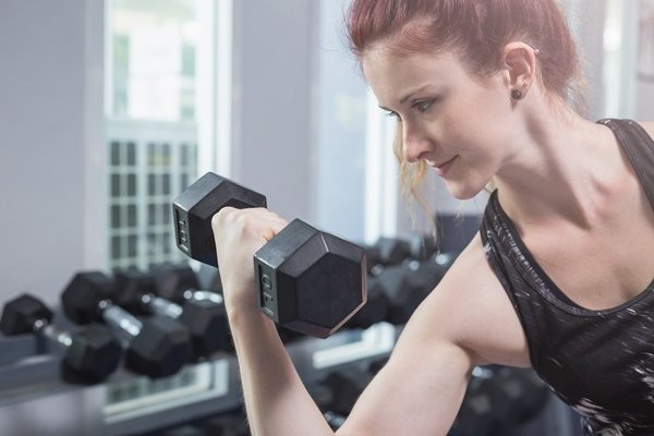 beautiful-young-caucasian-woman-doing-exercise-in-gym